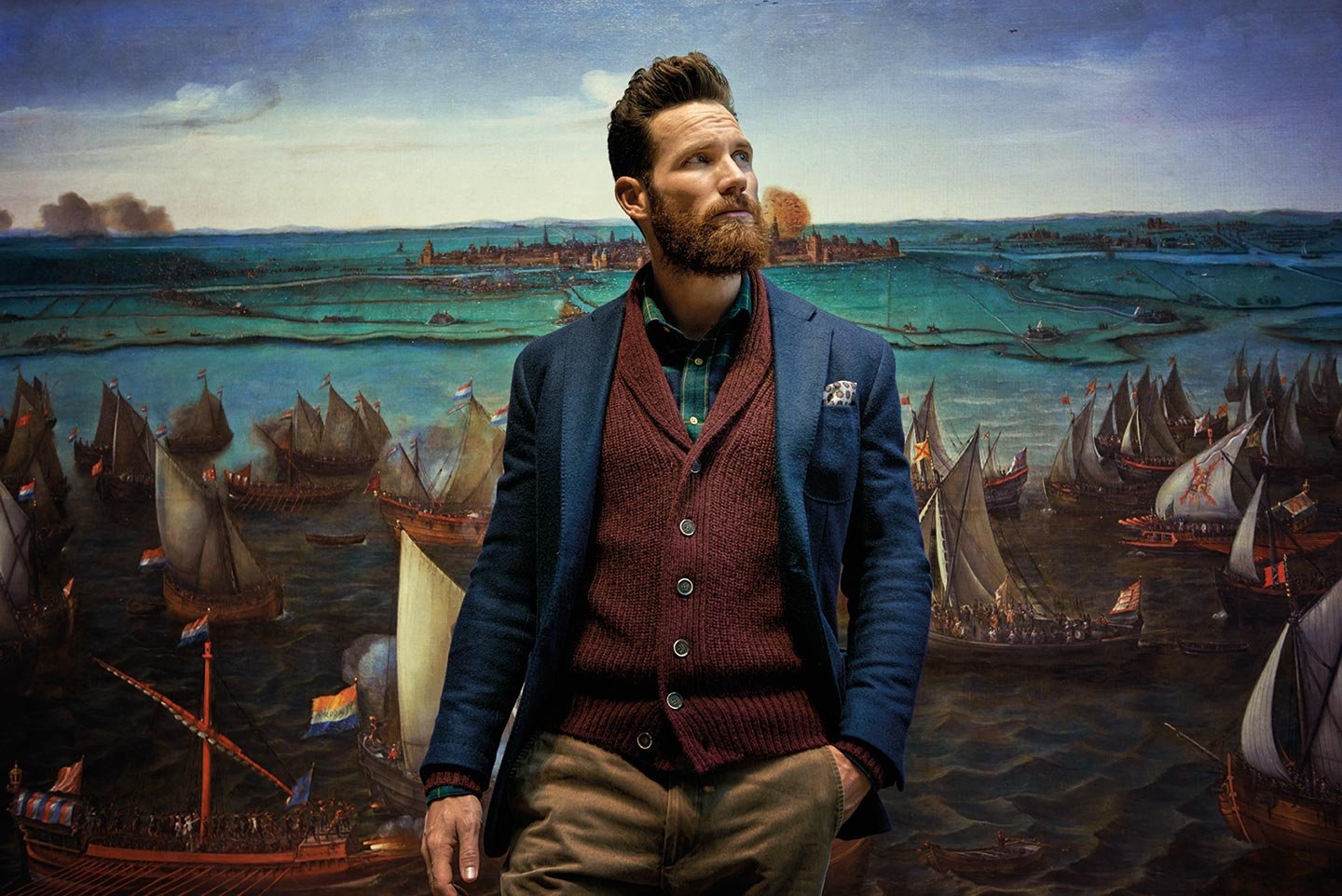 A man wearing a jacket in front of boats