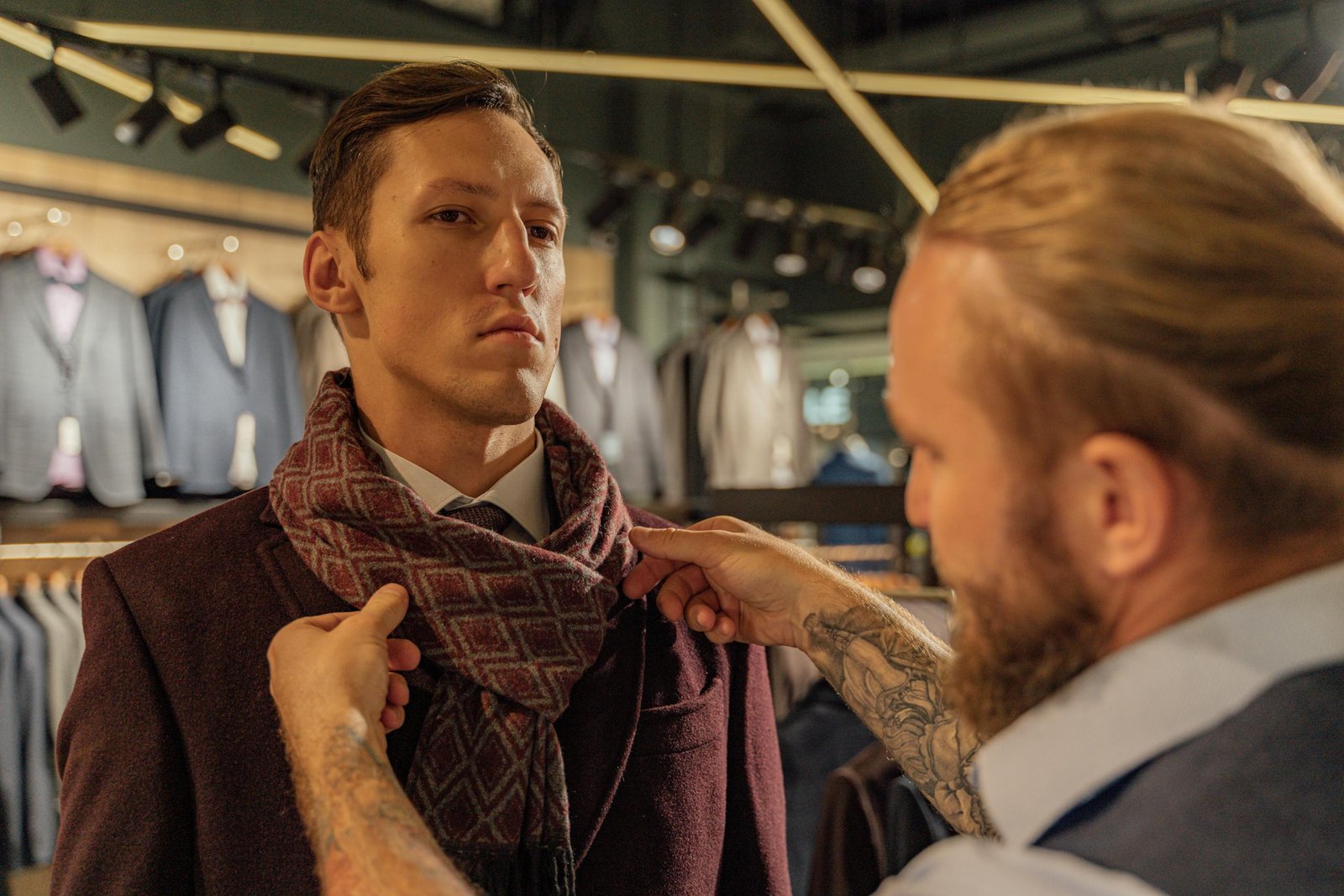 A Man Fixing a Client's Scarf