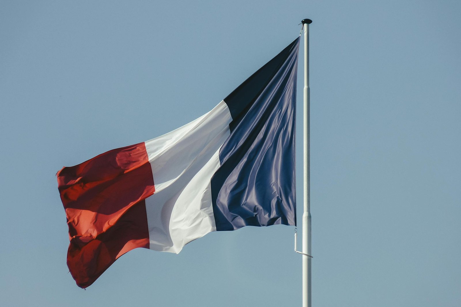 French flag against blue sky